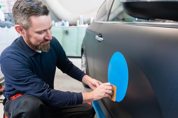 You may get practice installing company logos on cars