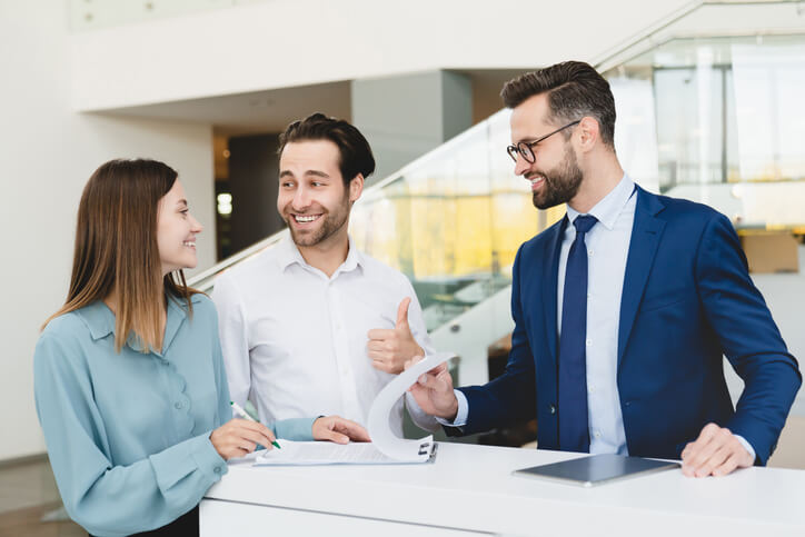 An automotive business manager with members of his sales team after automotive business manager training