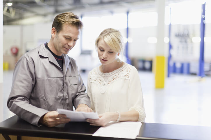 An automotive service advisor communicating with a female customer after service advisor training