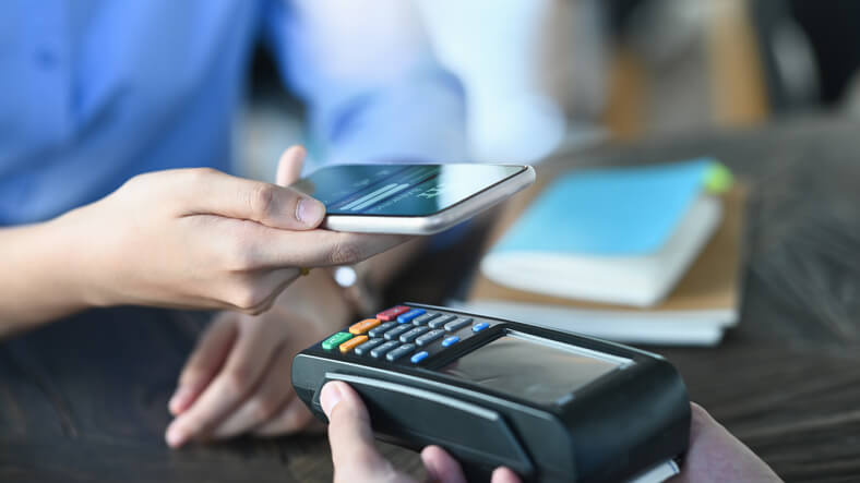 A service advisor training grad receiving a contactless payment