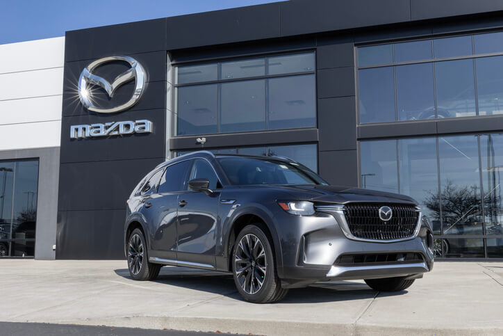 An auto mechanic discovering Mazda's latest release at a showroom