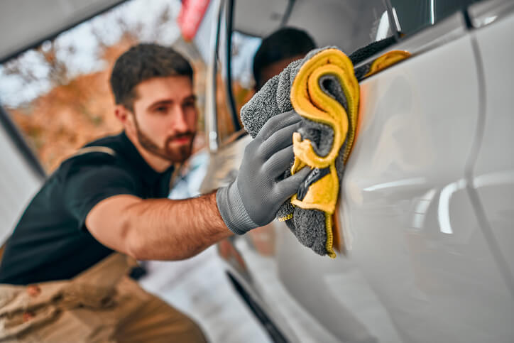 An auto detailing graduate working on a vehicle.