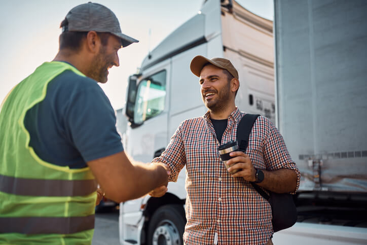 A male dispatcher shaking hands with a driver after dispatch college