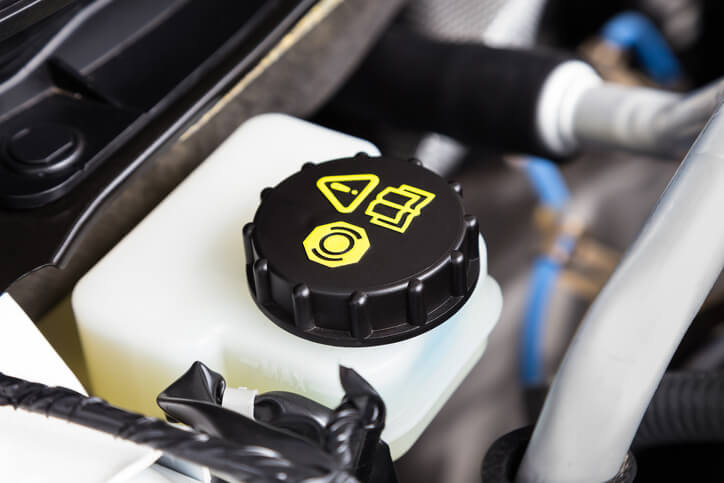 An EV engine brake fluid container, as explored in hybrid and electrical mechanic training