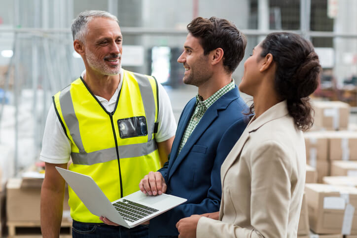 A smiling logistics project manager communicating with stakeholders after dispatch training