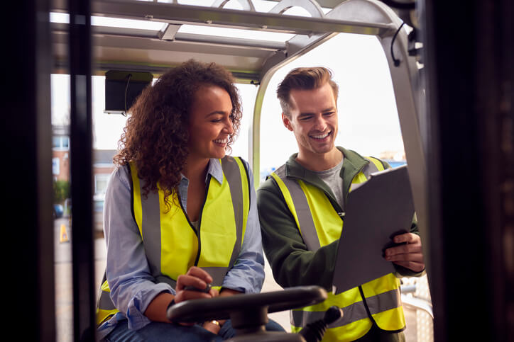 Two dispatch professionals interacting at a warehouse after dispatch training