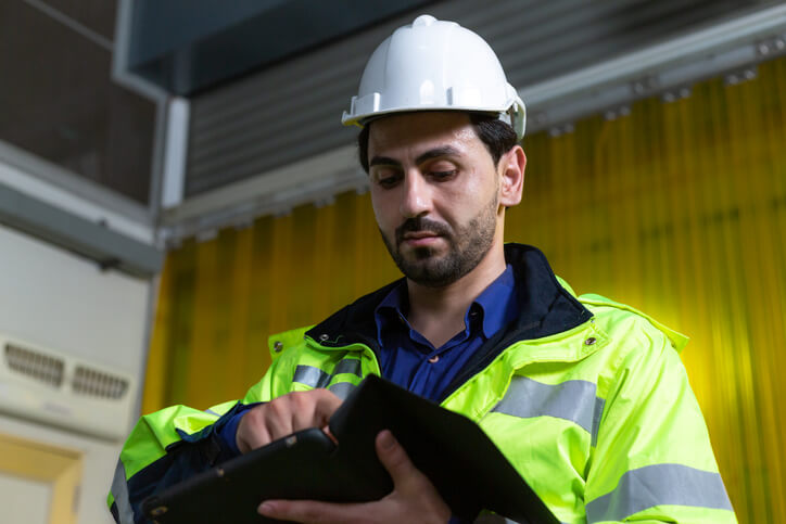 A focused male dispatch operations manager in a warehouse after dispatch training