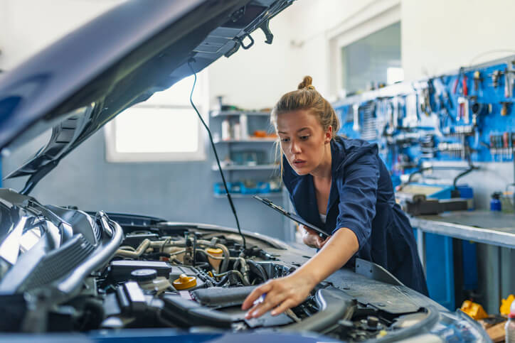 An auto mechanic inspecting an engine