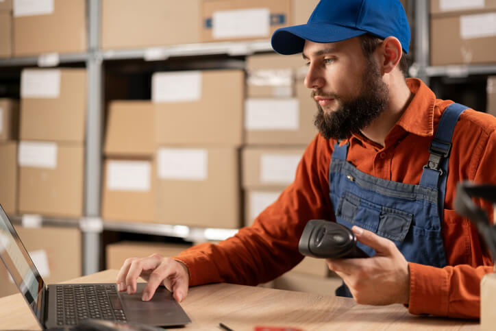 A male parts specialist managing inventory after his auto parts training