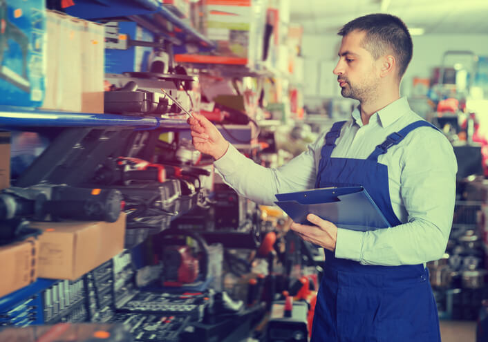 A male auto parts specialist inspecting inventory after completing auto parts training