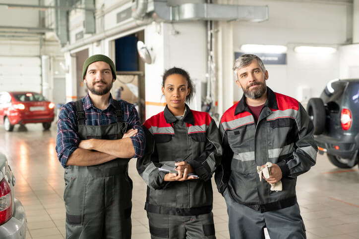 A group of auto parts clerks at a warehouse after their auto parts training