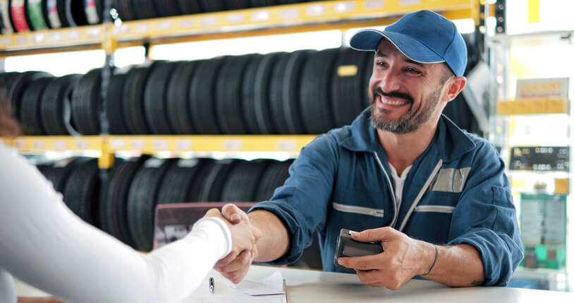 A parts specialist attending to a customer at a body shop after auto parts training