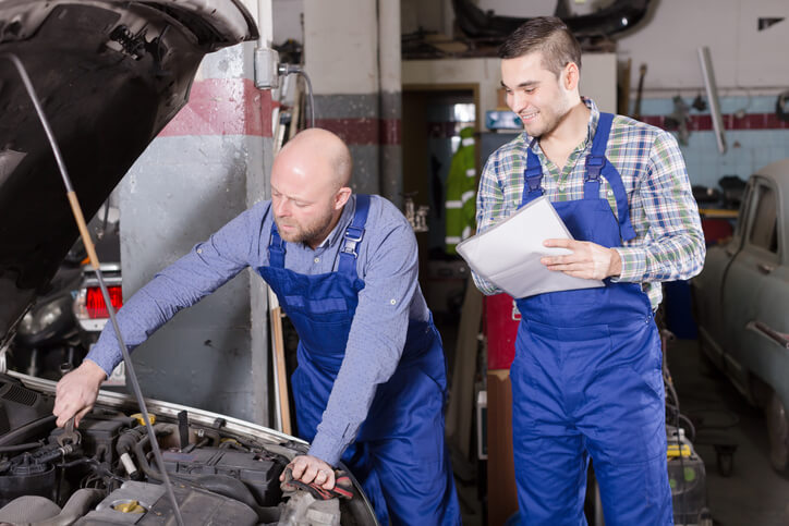 An auto mechanic student being mentored