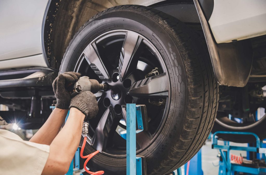 auto mechanic program grad changing a tire