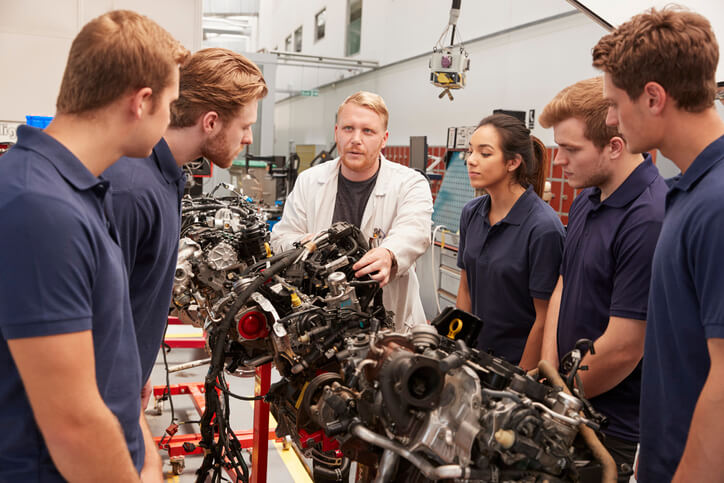 An auto mechanic instructor teaching a group of students