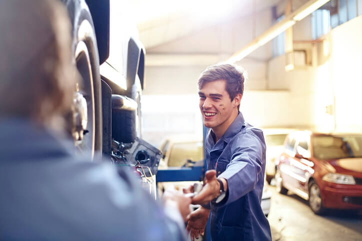 A smiling budding mechanic in auto parts training