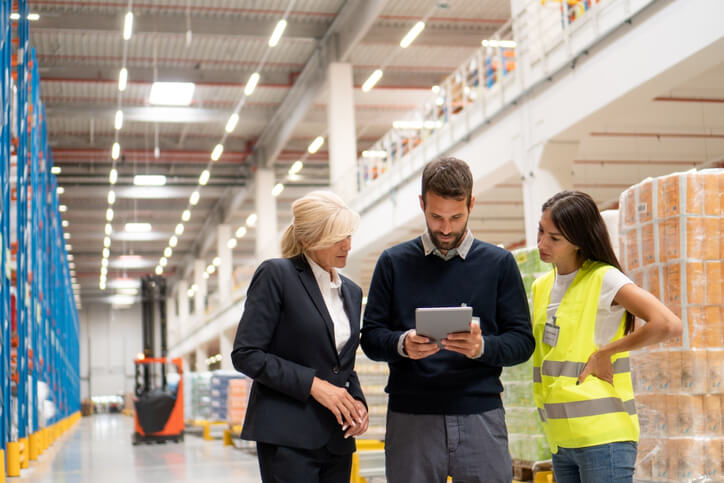 A male warehouse supervisor interacting with members of the team after dispatch training