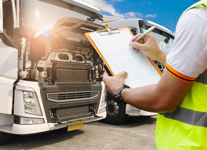 A dispatch training grad inspecting a truck