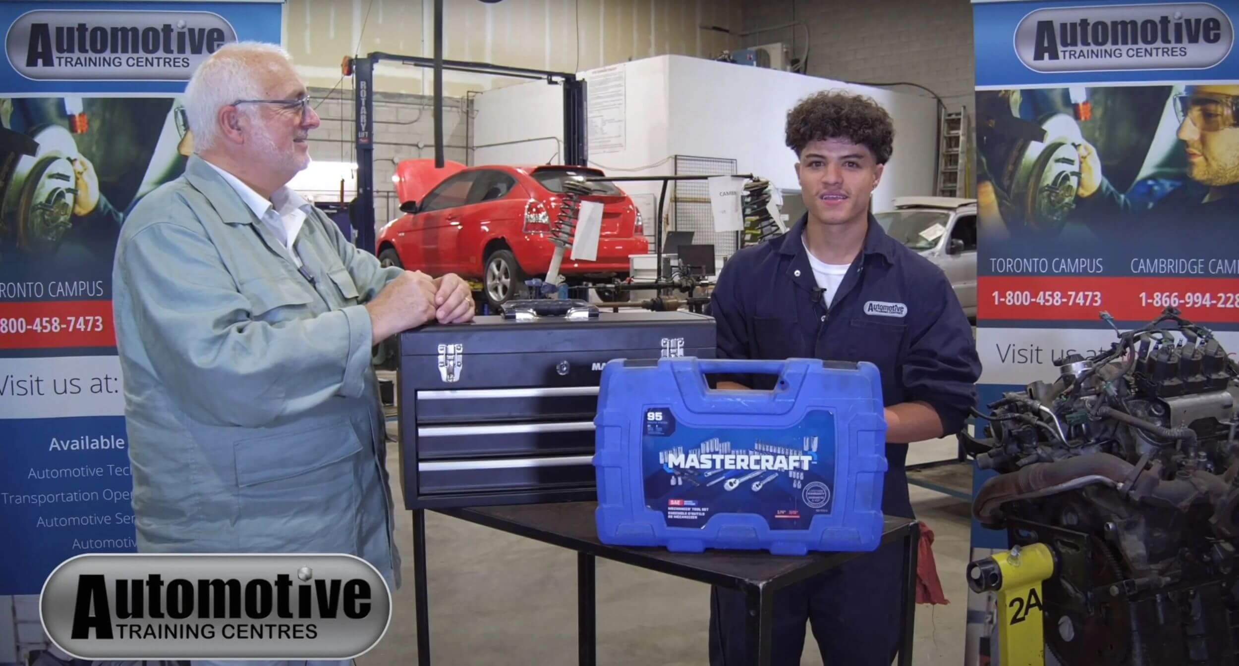 An auto mechanic training grad getting interviewed in a shop