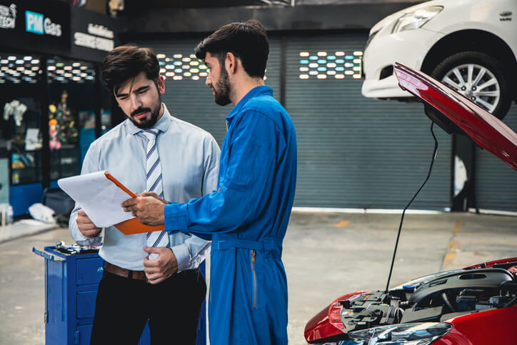 A male parts manager shaking hands with a customer after completing his auto parts training