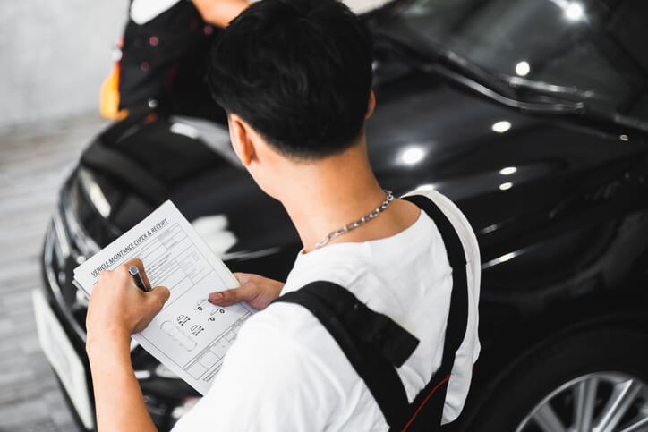 An auto body estimating training grad completing a maintenance checklist