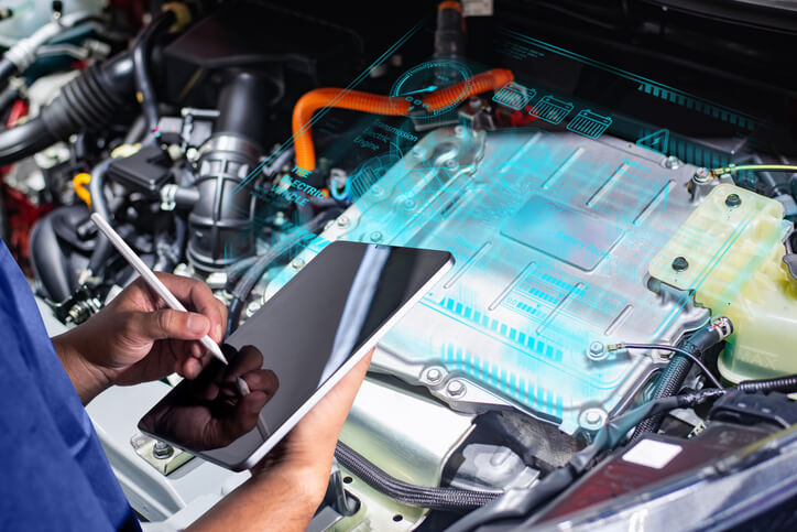 An auto parts training grad working on EV battery parts