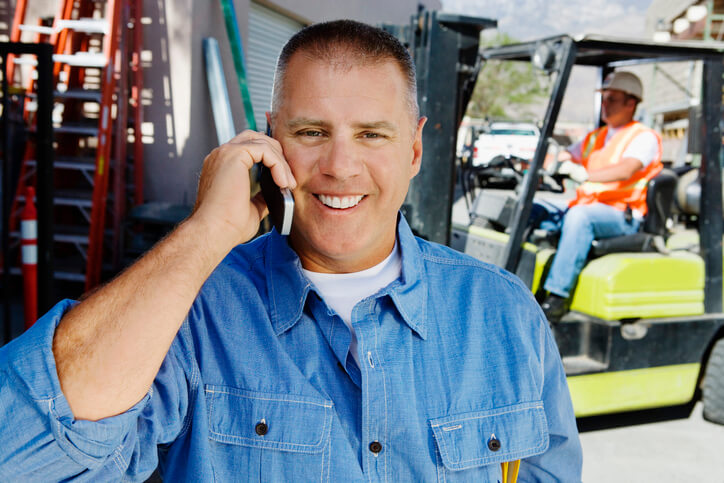 A male dispatcher communicating with a customer over the phone after completing his dispatch training