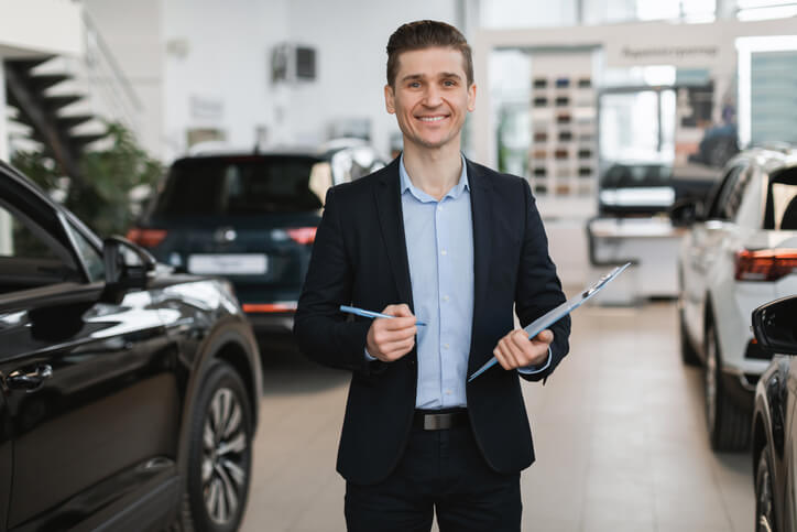 A friendly male customer service rep at a dealership after completing his dispatch training