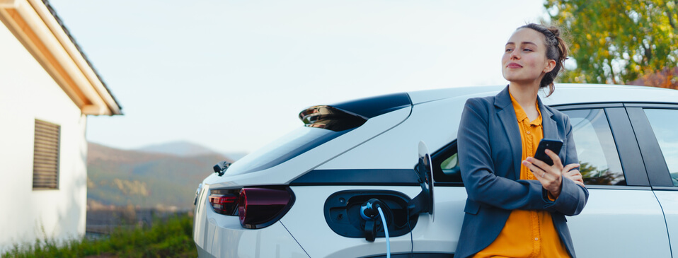 An automotive training graduate waiting for their electric vehicle to charge