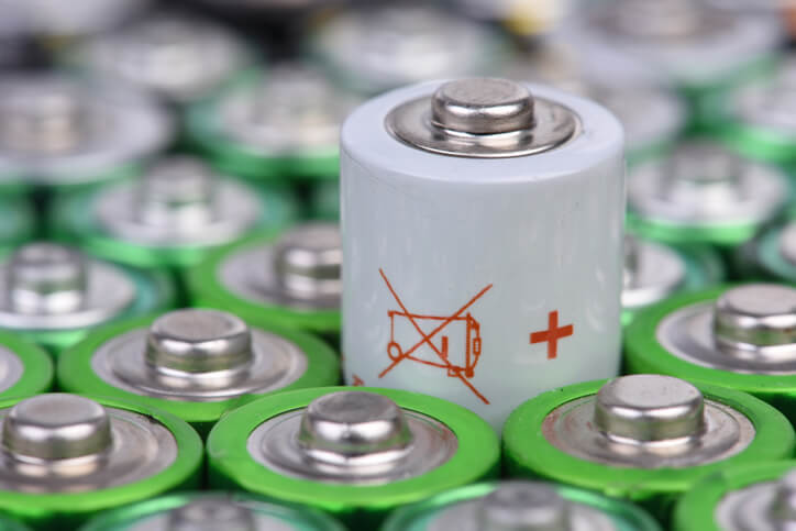 A used battery cell marked for recycling, as those explored in automotive school