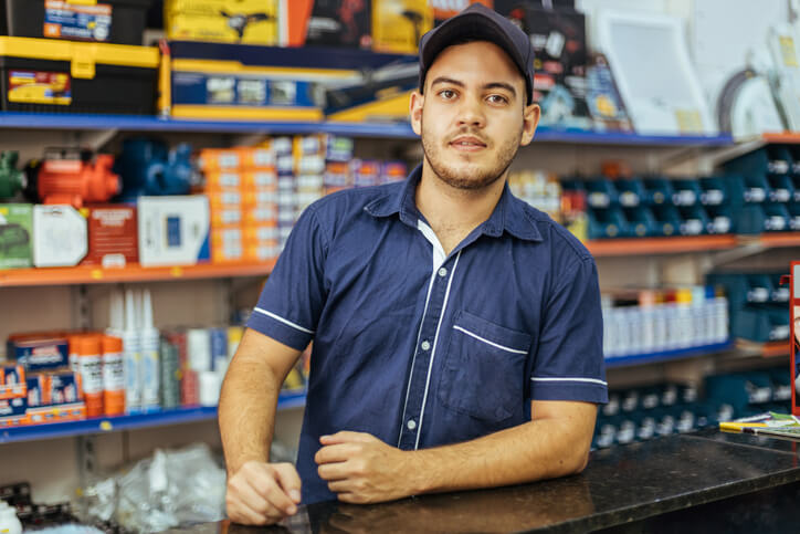 A male parts manager at an auto shop after completing his auto parts training