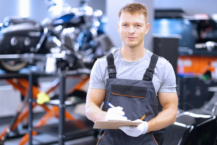 A male auto parts professional checking inventory after completing his auto parts training