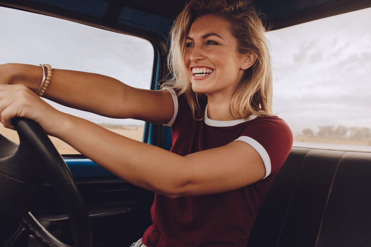 An automotive school graduate driving a pickup truck