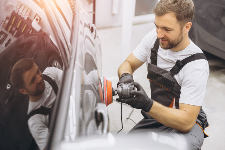 An auto detailing training grad polishing silver car