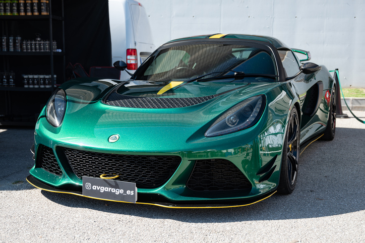 A British green Lotus Exige parked outdoors, to be explored in automotive school