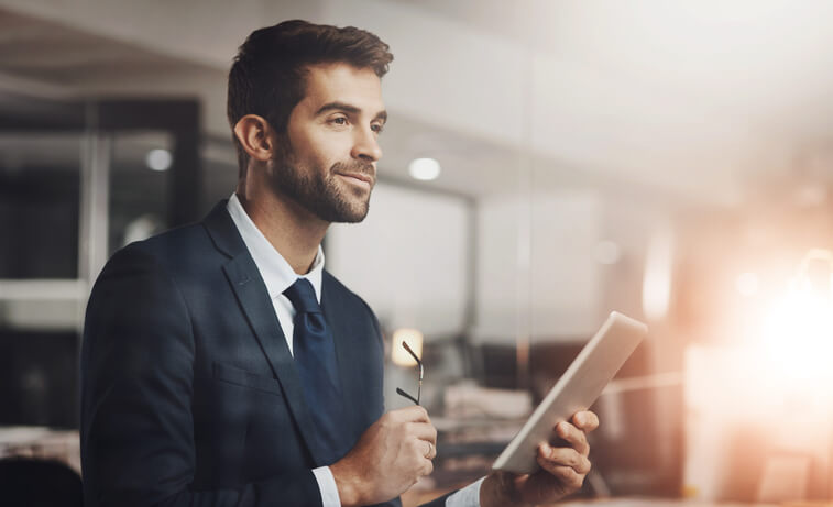 A professional individual preparing for a hybrid technology job interview, reviewing questions on a digital tablet