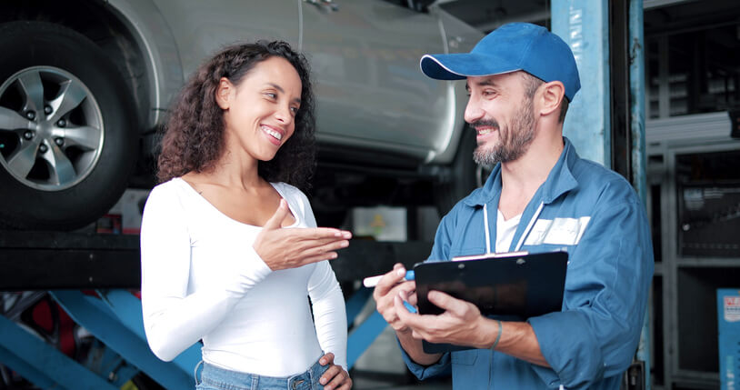 A friendly auto parts manager assisting a female customer after completing his application parts training