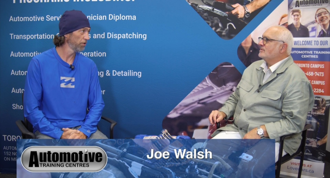 Joe Walsh interacting with an instructor at our auto mechanic school