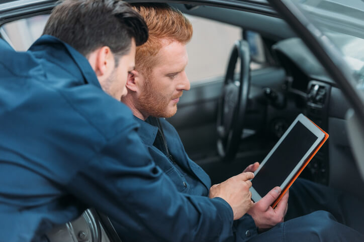 A student using a scan tool to interpret codes during hybrid and electrical mechanic training