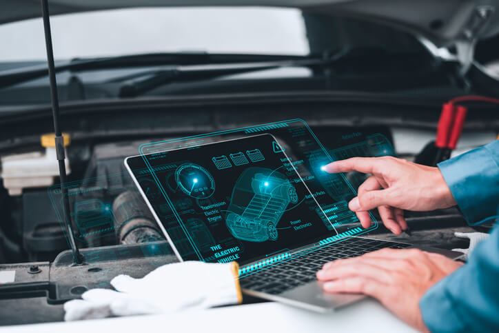 A mechanic using Internet of Things technology to inspect a car remotely