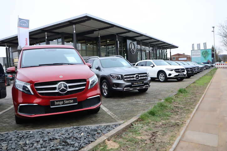 A row of cars displayed at an automotive dealer show to be explored in auto detailing training.