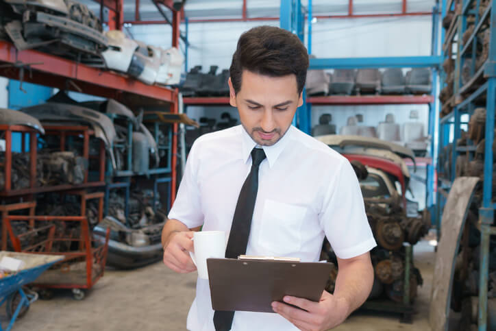 A budding parts clerk learning about inventory management during auto parts training.