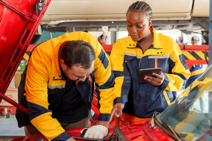 A technician demonstrating automotive technology in an automotive school.