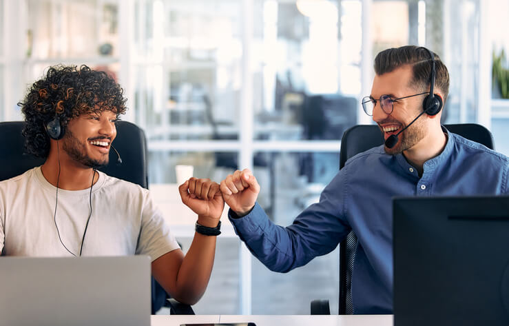 A dispatch training grad fist-bumping a colleague