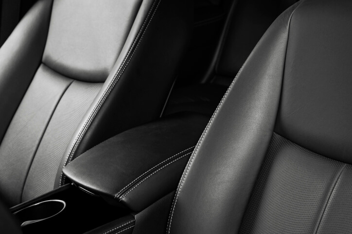 A close-up of a well-maintained leather car interior in auto detailing training.