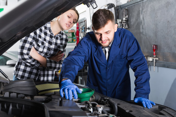 A student learns auto repair techniques in a hands-on auto mechanic training environment.