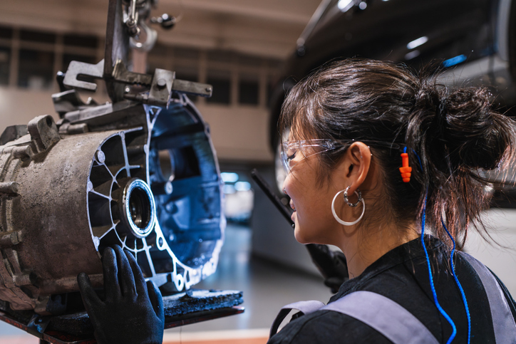 An automotive school student learning about EV powertrain components