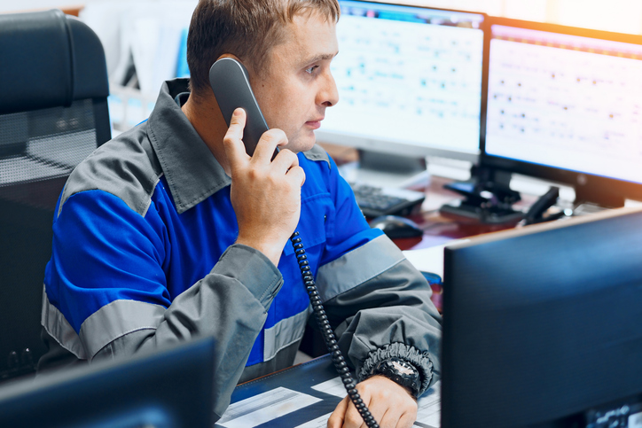 dispatch training grad on the phone in an office