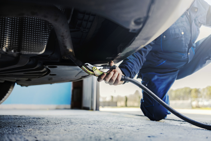 An emissions specialist conducting a vehicle emissions test