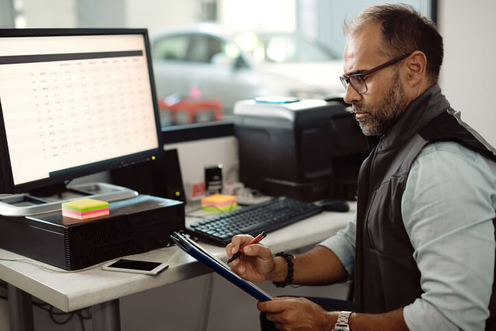 A dispatcher analyzing fuel costs and budgeting on a computer after dispatch training